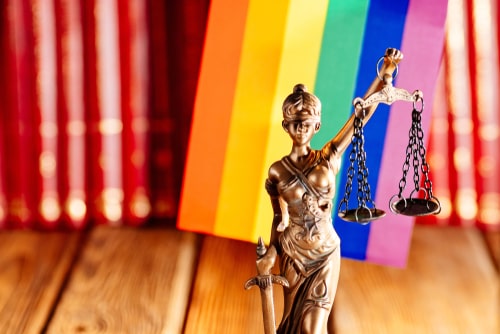 Rainbow flag and justice statue, Los Angeles LGBT discrimination lawyer concept