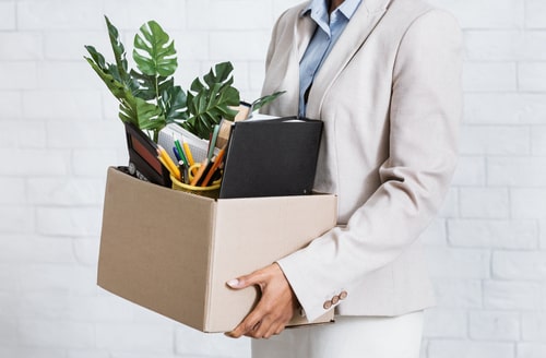 Woman leaving office with box, Los Angeles wrongful termination lawyer concept