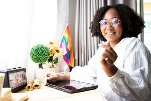 Businesswoman with rainbow flag, Van Nuys LGBT discrimination lawyer concept