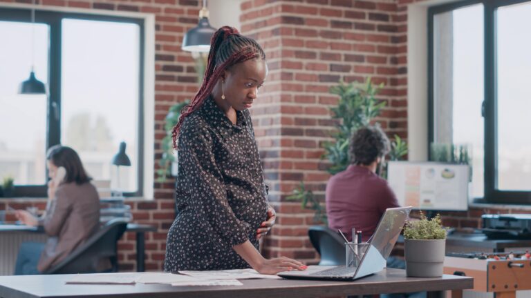 Pregnant employee learning her rights in the workplace